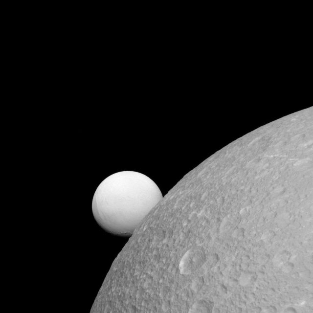 Dione with Enceladus in the background (Image NASA/JPL-Caltech/Space Science Institute)