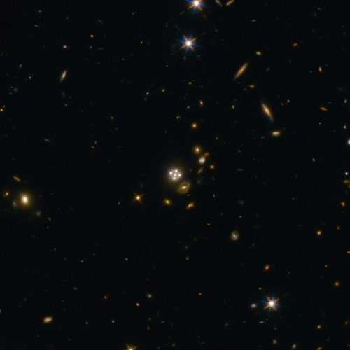 The quasar HE0435-1223 seen through a gravitational lens that creates four images of it (Image ESA/Hubble, NASA, Suyu et al.)