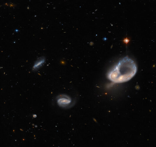 Arp-Madore 417-391, or simply AM 417-391, with other galaxies and stars