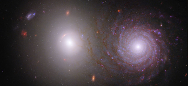 An elliptical galaxy on the left and a spiral galaxy on the right